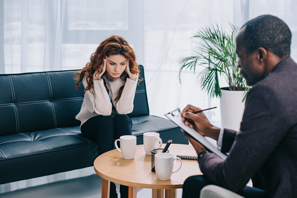 a young woman in therapy covered by First Health mental health rehab insurance