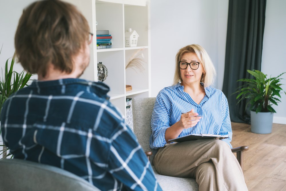 man speaking to a therapist during mental health treatment covered by ComPsych mental health rehab coverage